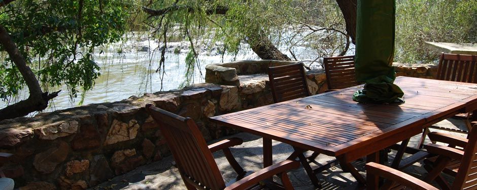 Table set for a meal on the river bank at Fish Eagle cottage