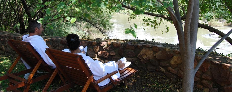 Loungers under the trees with a river view